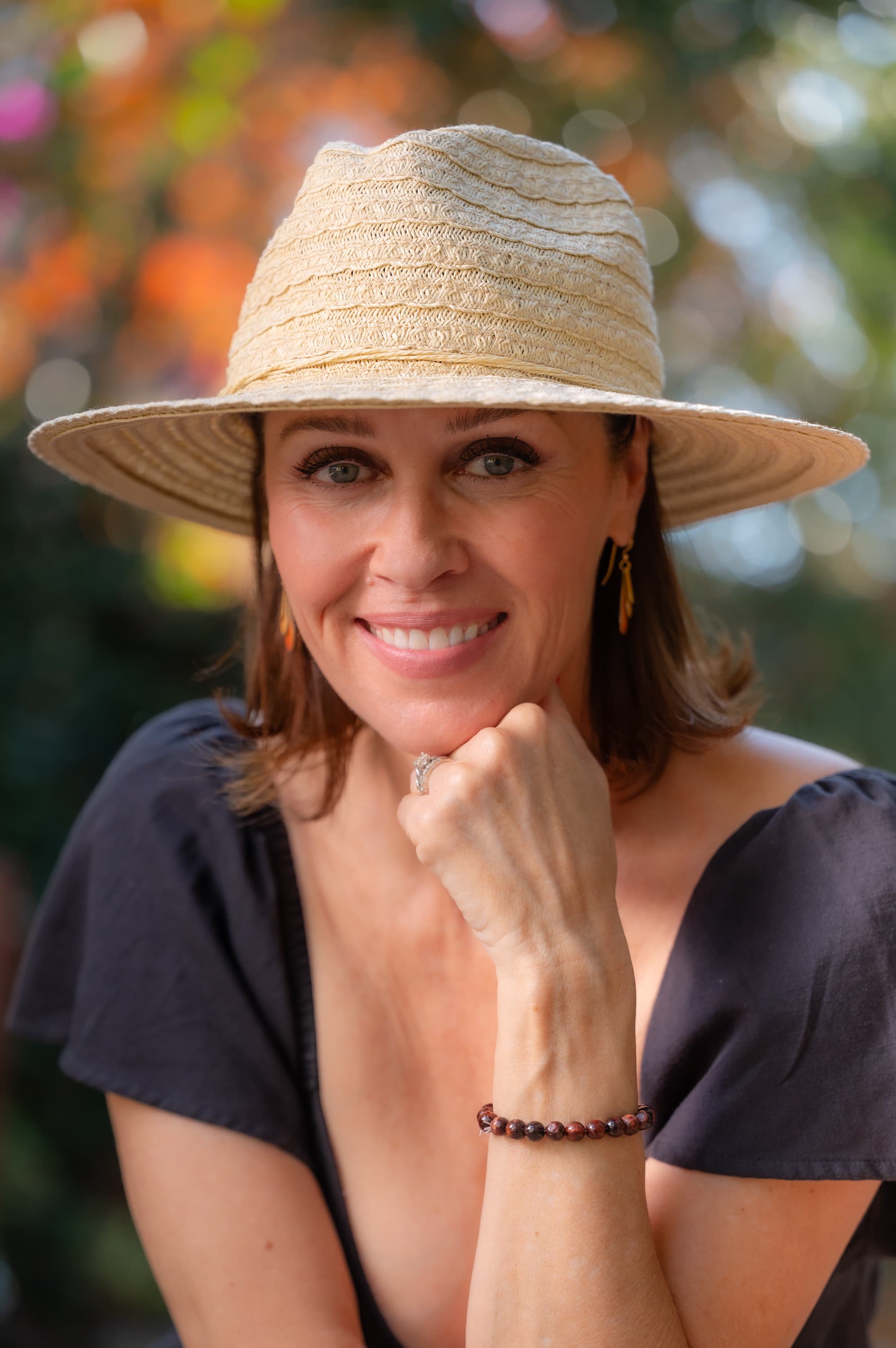Carrie Kurtz, somatic trauma coach, smiling outdoors in warm afternoon light